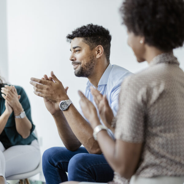 5 ways to say no to drugs . An image of a man and two women clapping in a support group.