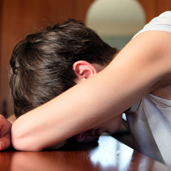 Can alcohol blackouts cause personality changes - an image of a man sleeping with his head resting on a table