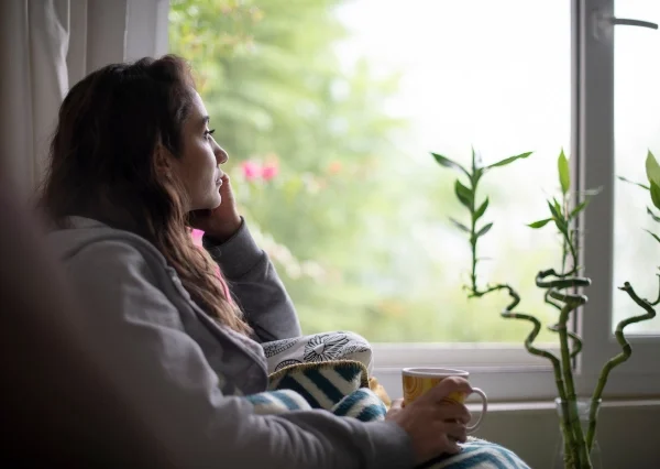 can sobriety cause depression? An image of a woman looking out the window